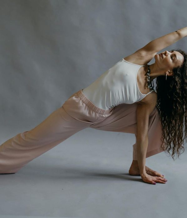 Woman in a calm yoga pose symbolizing grace and inner balance.